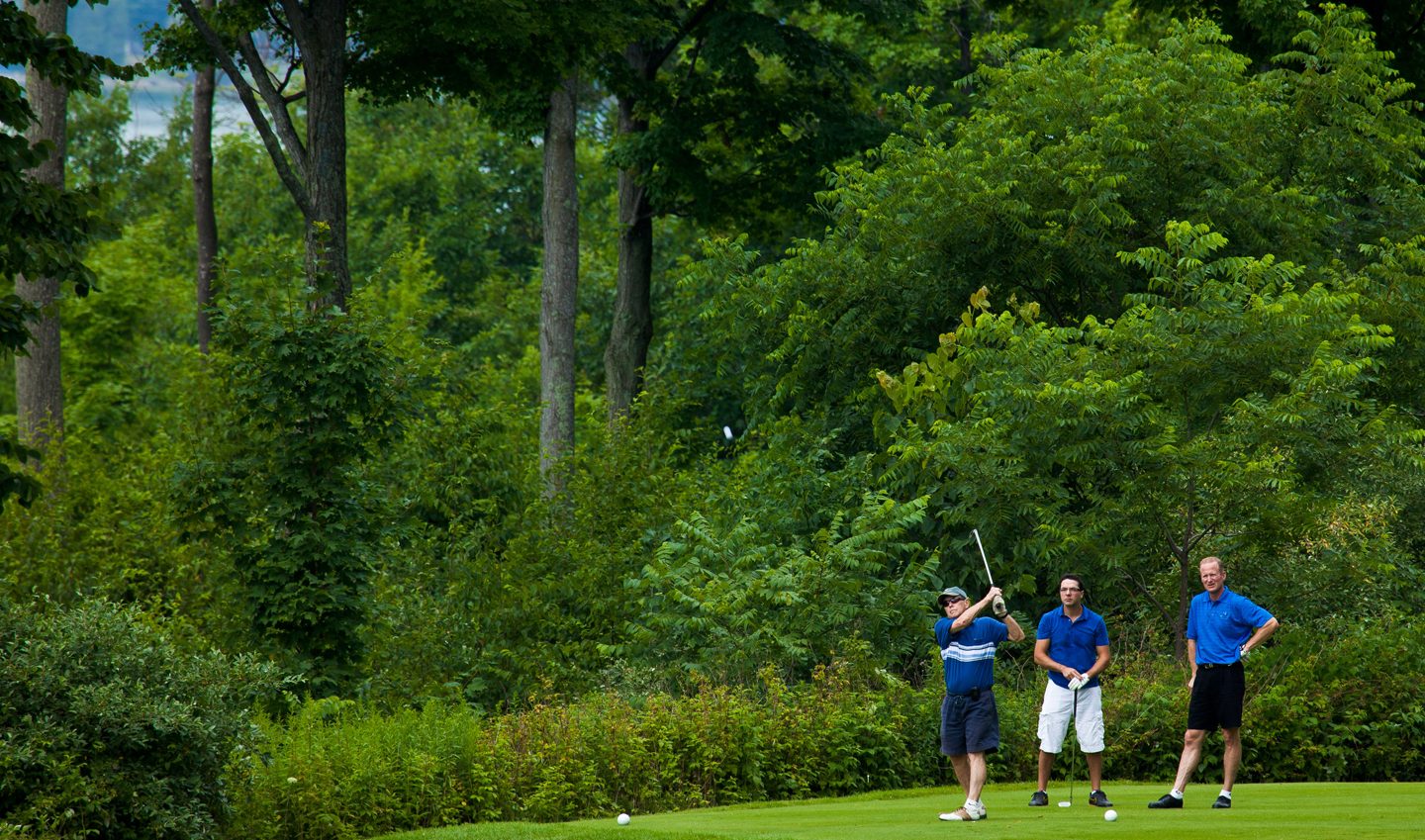 Group of Men Teeing Off