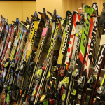 A line of various skis for sale at the Antrim Ski Academy Ski Swap