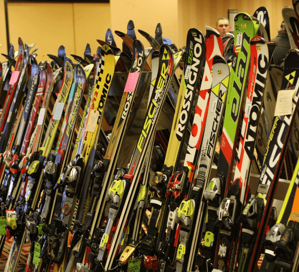 A line of various skis for sale at the Antrim Ski Academy Ski Swap