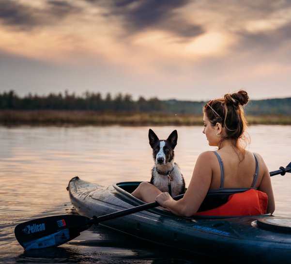 Woman Kayaking with Dog in Kayak