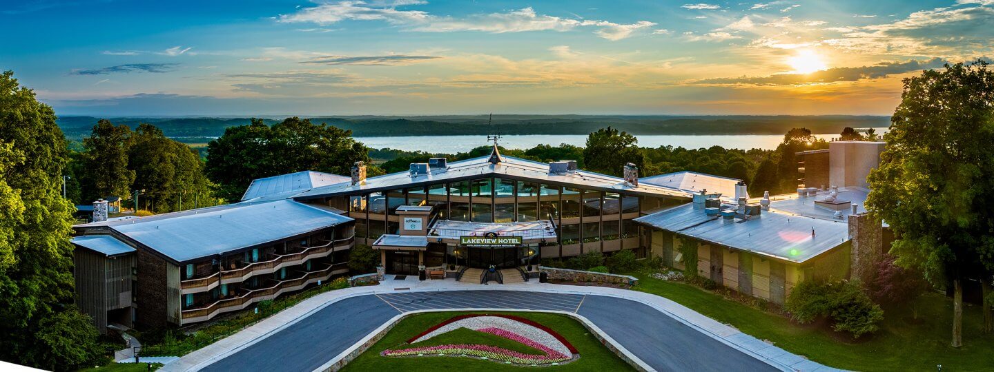 Aerial view of The Lakeview Hotel with the sun setting and Lake Bellaire in the background