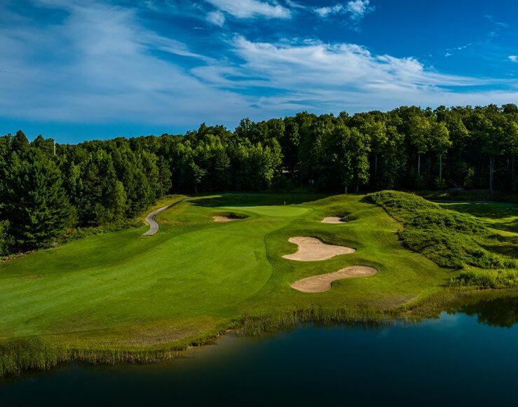 Aerial Photo of Hawk's Eye GC's Hole #2 Green with Sand Traps and a Pond in the front of the green