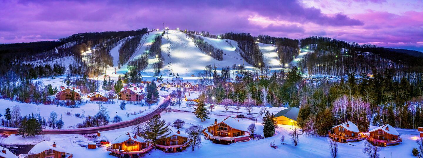 Aerial of Schuss Mountain covered in snow at Night